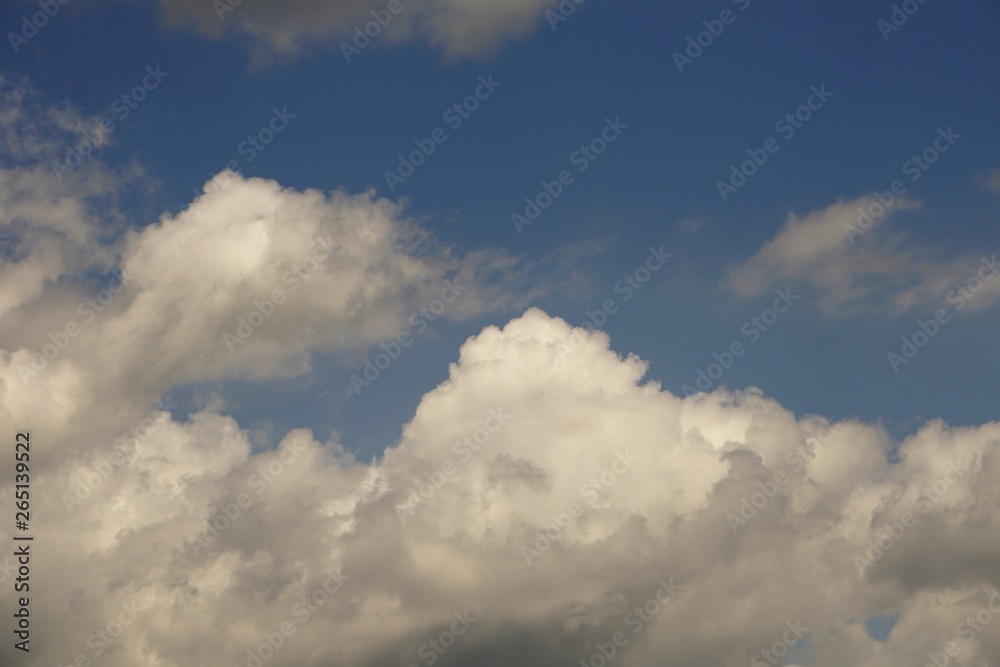 Amazing white fluffy clouds and blue sky on the background, Spring in Georgia USA.