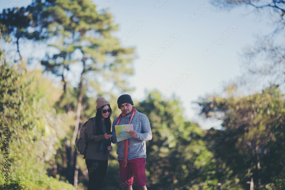 Couple standing beside the tree for view map. Couple standing beside the tree for view map.