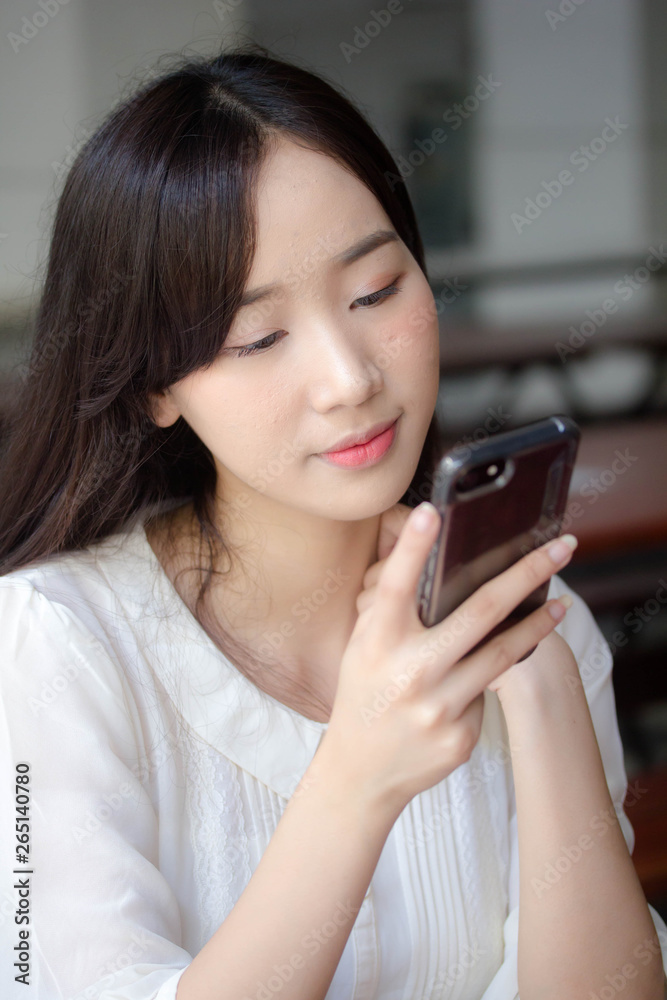 portrait of thai china adult office girl white shirt using her smart phone