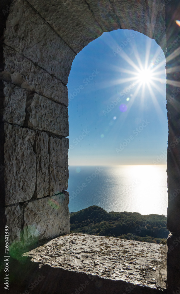 View from the tower on Akhun mountain. Sun rays over the Black Sea and bright blue sky. Sochi, Russia.