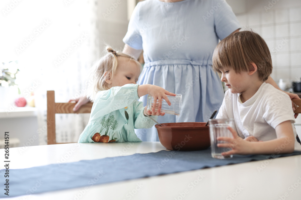 Little sibling with mother make linen flour dough Little sibling with mother make linen flour dough