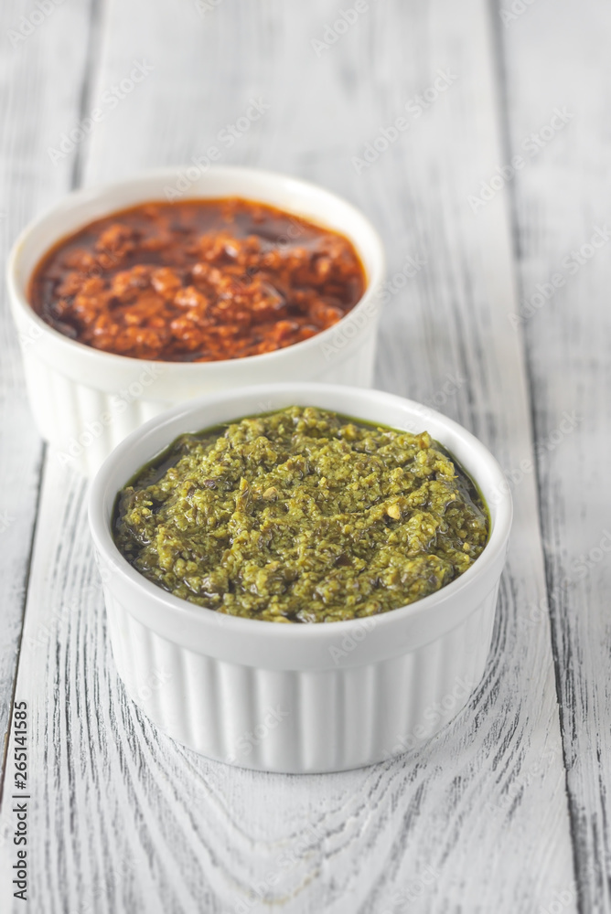 Bowls of classic and sun-dried tomato pesto Bowls of classic and sun-dried tomato pesto