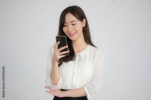portrait of thai china adult office girl white shirt using her smart phone