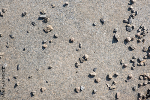 Small granite stones scattered on a granite slab