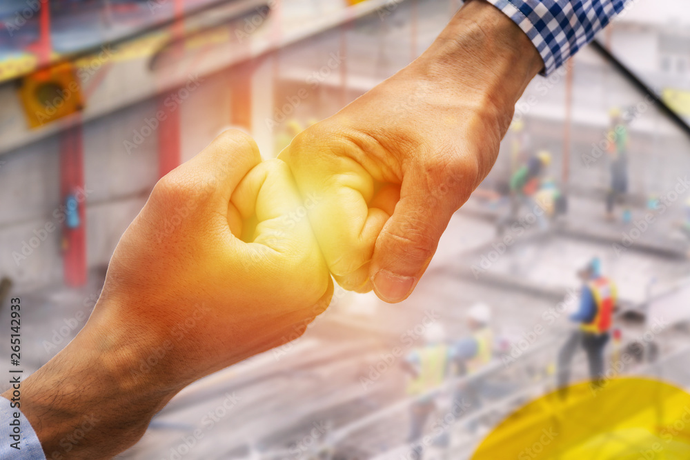 Fist bump and construction industrial project complete. Close up hands of professional engineer men handshake together after worker successful double exposure. engineering and architecture concept.