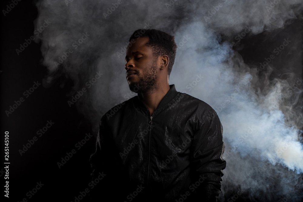 Portrait of handsome young African man on black background Portrait of handsome young African man on black background