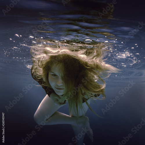 Portrait of a girl swimming underwater © Dmitry