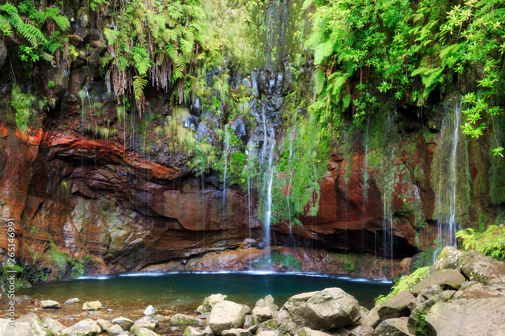 Fototapeta premium Beautiful landscape view of the 25 Fontes falls, a cascade waterfall at the end of a levada hike on the island Madeira