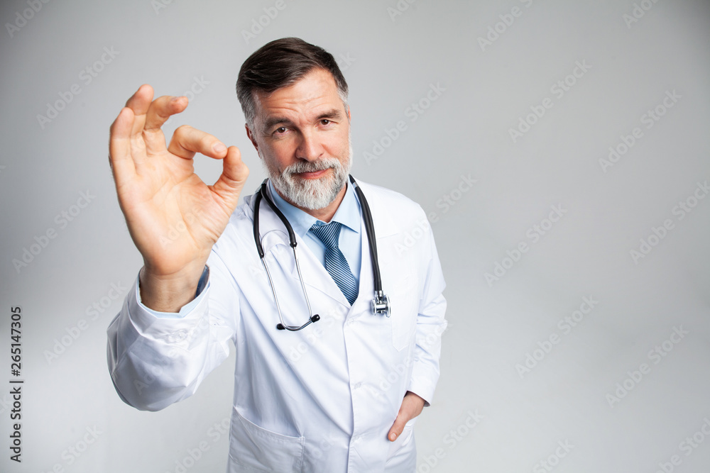Happy smiling doctor with thumbs up gesture, isolated on white background. Happy smiling doctor with thumbs up gesture, isolated on white background.