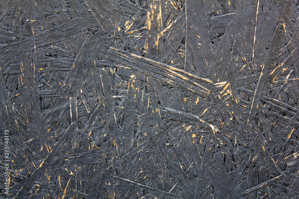 black gray fiberboard with damage closeup . rough surface texture black gray fiberboard with damage closeup . rough surface texture