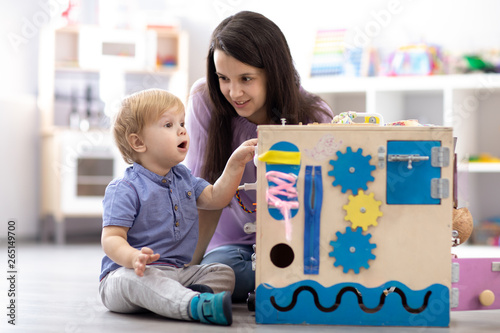 Child with teacher playing ...