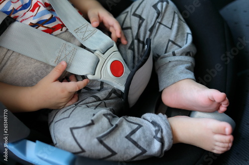 baby sitting in car seat with life safety belt lock protection