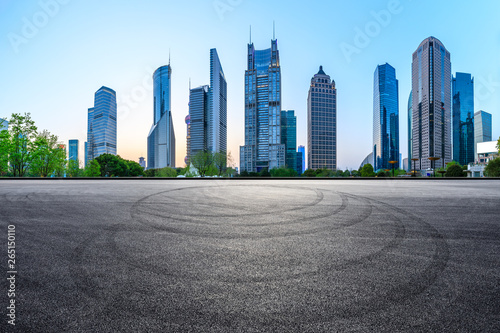 Asphalt race track ground and modern skyline and buildings in Shanghai at night panoramic view