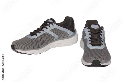 A pair of gray sports sneakers on a white isolated background