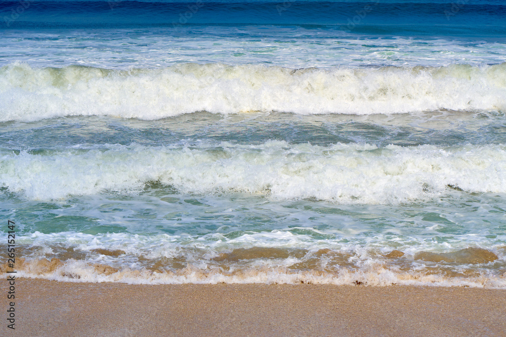 Ocean waves on the famous Kuta Beach. Nature background.