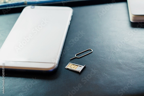 nano sim card in the storage and SIM card adapter to change the size to a small SIM card and the usual SIM card size on a black background, bought in Thailand requires passive paste. Register with