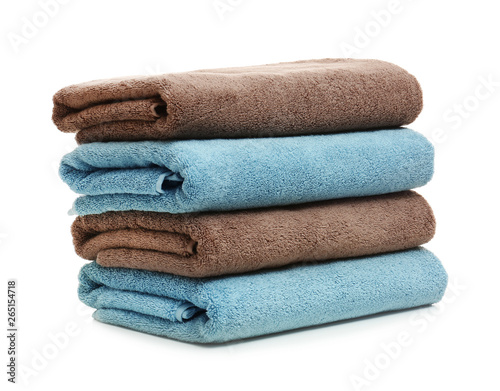 Stack of clean folded towels on white background