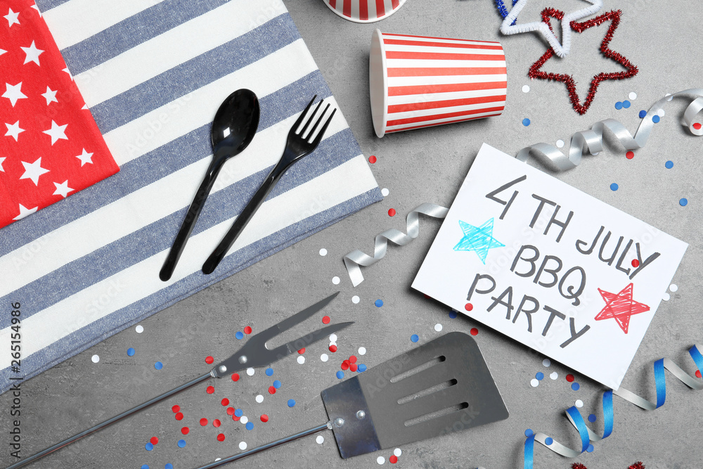 Flat lay composition with barbecue tools and card on color background. USA Independence Day