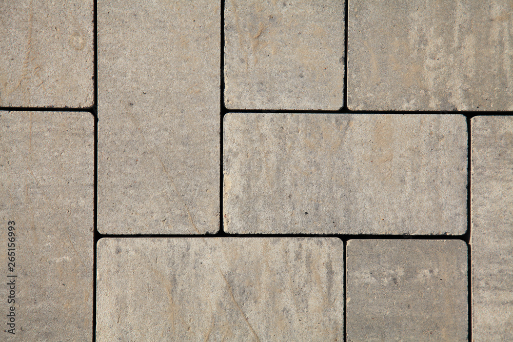 Paving slabs of gray blocks regular shape close-up. New pavement in the city park Paving slabs of gray blocks regular shape close-up. New pavement in the city park
