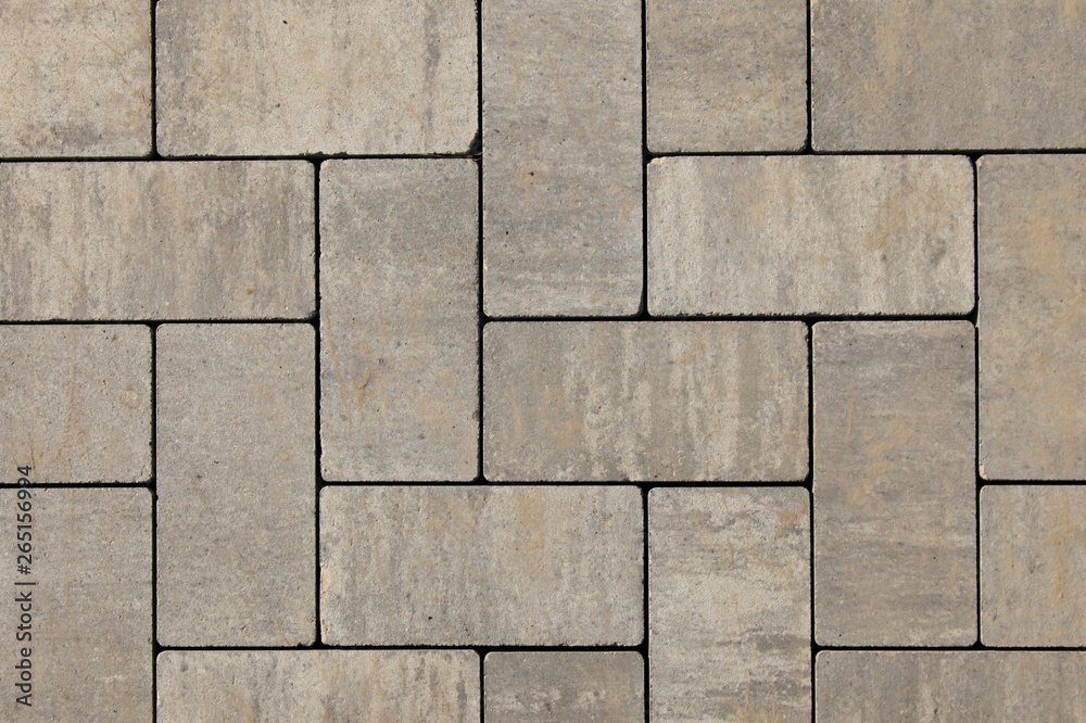 Paving slabs of gray blocks regular shape close-up. New pavement in the city park