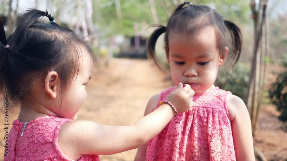 Asian little child testing the taste of fresh mulberry balls the beginning in the garden, First time to eating. Playing is learn to children. Asian little child testing the taste of fresh mulberry balls the beginning in the garden, First time to eating. Playing is learn to children.