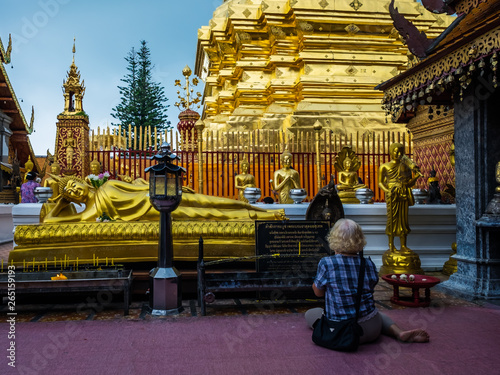 woman in prayerwat phra that doi sutep chiang mai thailand most famous buddhist gold temple  photo