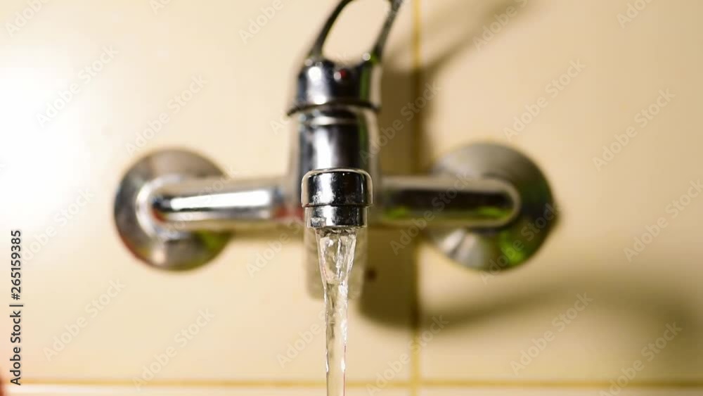 Running clean drinking water in the domestic kitchen old faucet close up selective focus Running clean drinking water in the domestic kitchen old faucet close up selective focus