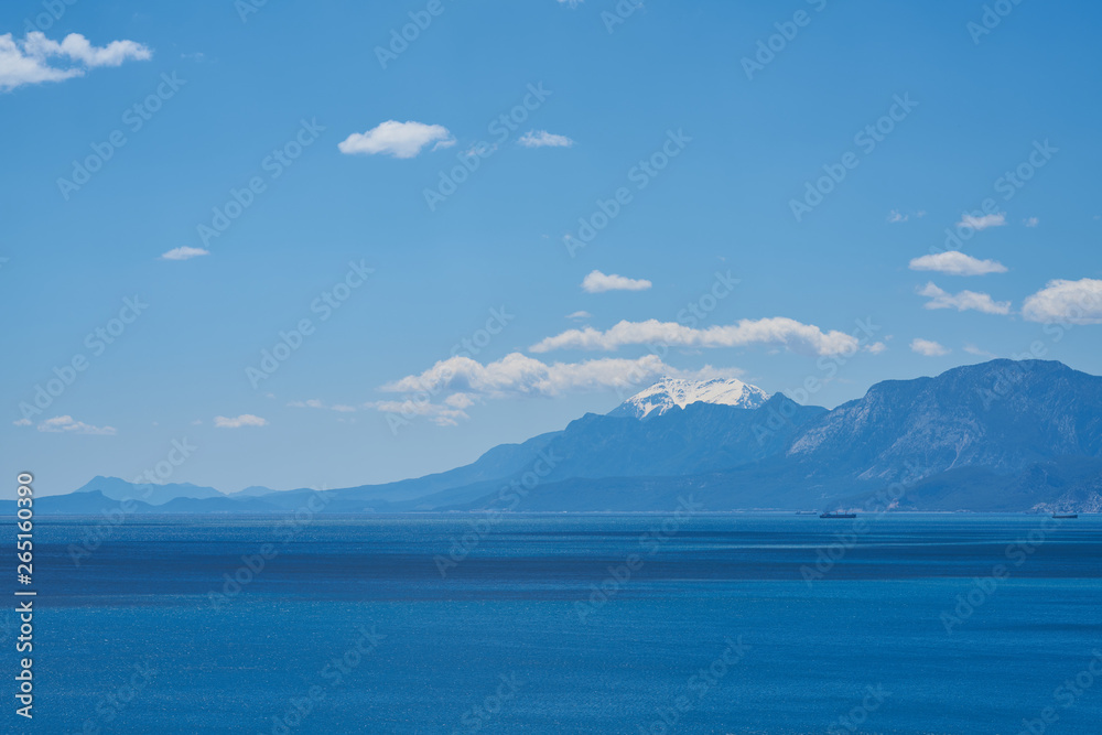 Mountain, sea, sky and white clouds
