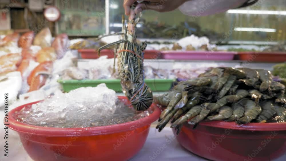 Row of lobsters in the Asian market. Lobsters are cooking for dinner in