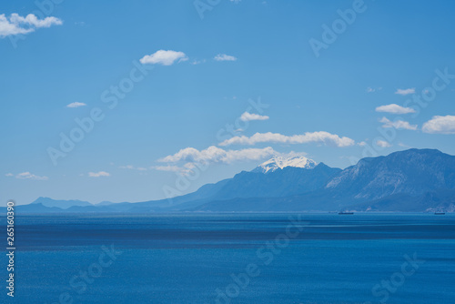 Mountain, sea, sky and white clouds