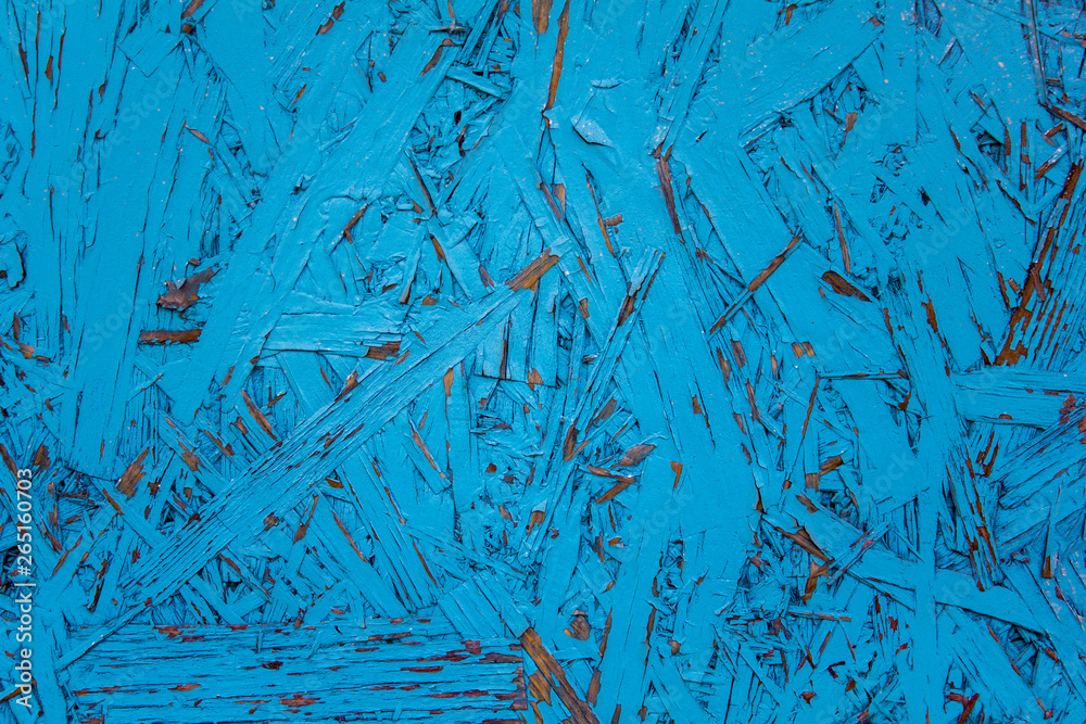 fibreboard with blue peeling paint closeup. rough surface texture fibreboard with blue peeling paint closeup. rough surface texture