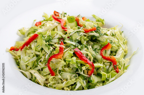 Salad with fresh cabbage and cucumber. On white background