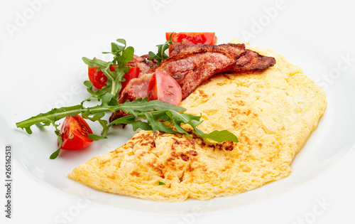 Omelet with bacon and tomatoes on white background