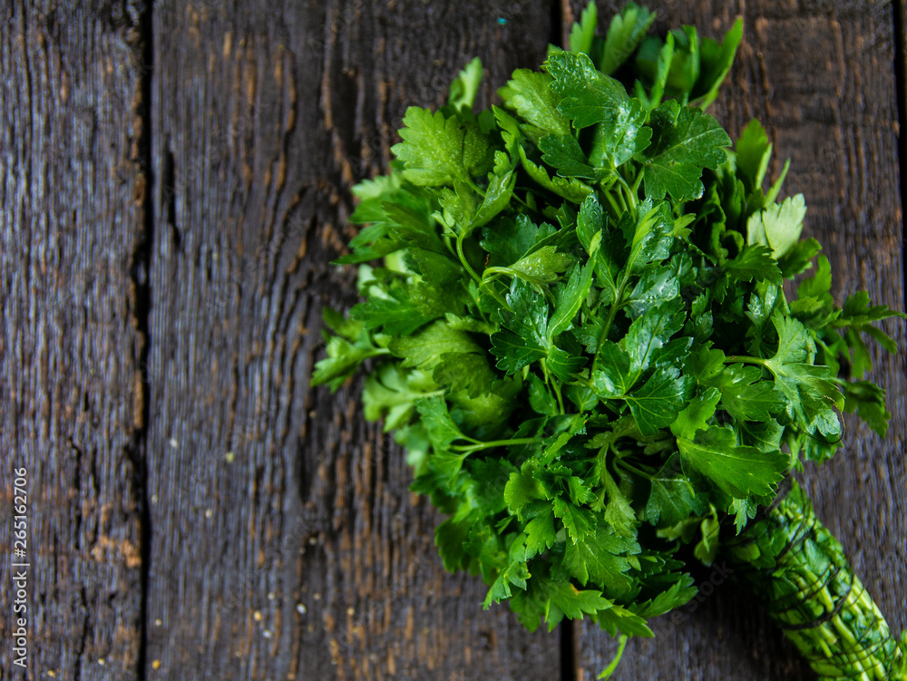 Fresh parsley leaves on wooden background. Top view Fresh parsley leaves on wooden background. Top view