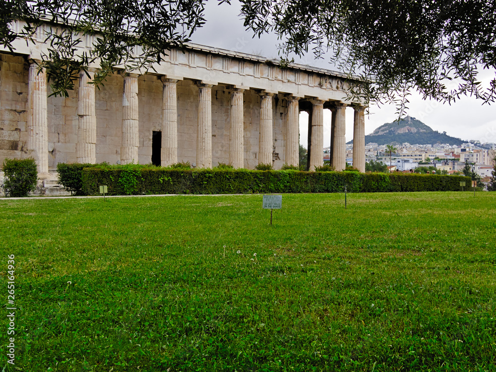 Fototapeta premium Temple of Hephaestus in Athens, Greece. Grass in the foreground with label 