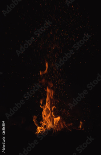 Camp fire in the night,bright flames, black background