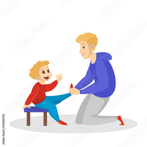 Father help son to tie the shoe laces