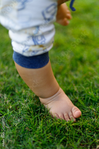 Baby feet walking on grass