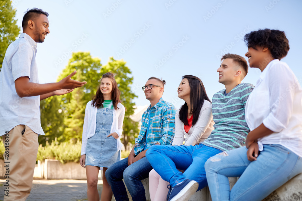 people, friendship and communication concept - group of happy international friends talking in city people, friendship and communication concept - group of happy international friends talking in city