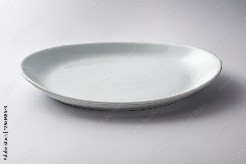 Isolated empty white oval plate Isolated empty white oval plate