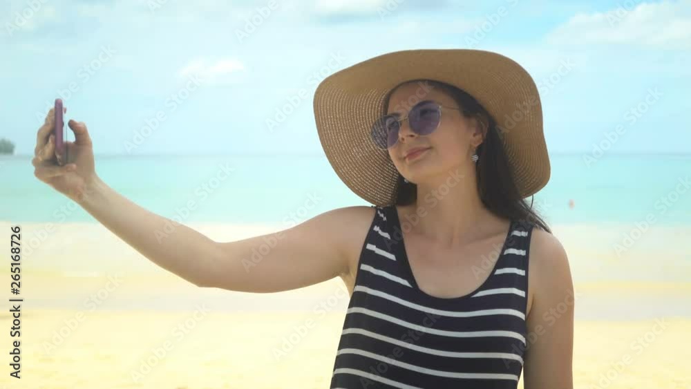 beautiful young woman taking selfie on beach. beautiful young woman taking selfie on beach.