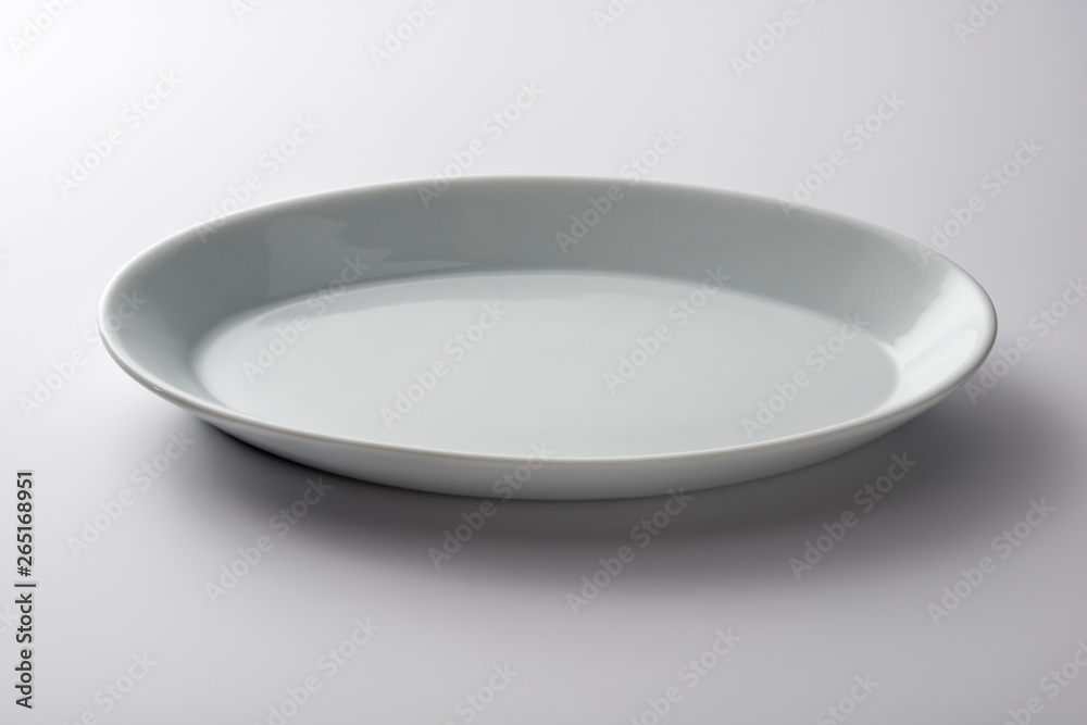 Isolated empty white oval plate Isolated empty white oval plate