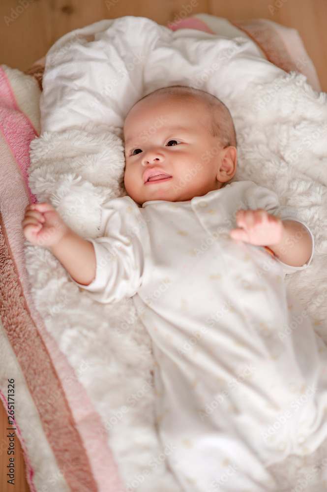 Cute baby boy in a white light bedroom Newborn baby is cute. In bedding for children born - images Cute baby boy in a white light bedroom Newborn baby is cute. In bedding for children born - images