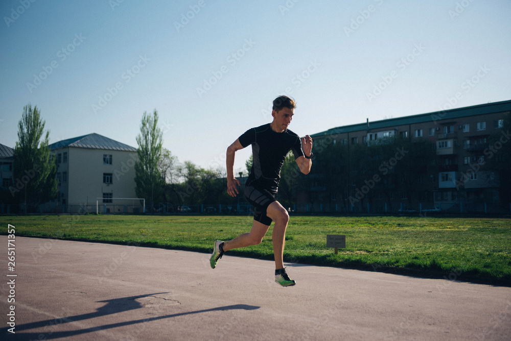 Fototapeta premium sprinter runs fast on a treadmill at the stadium