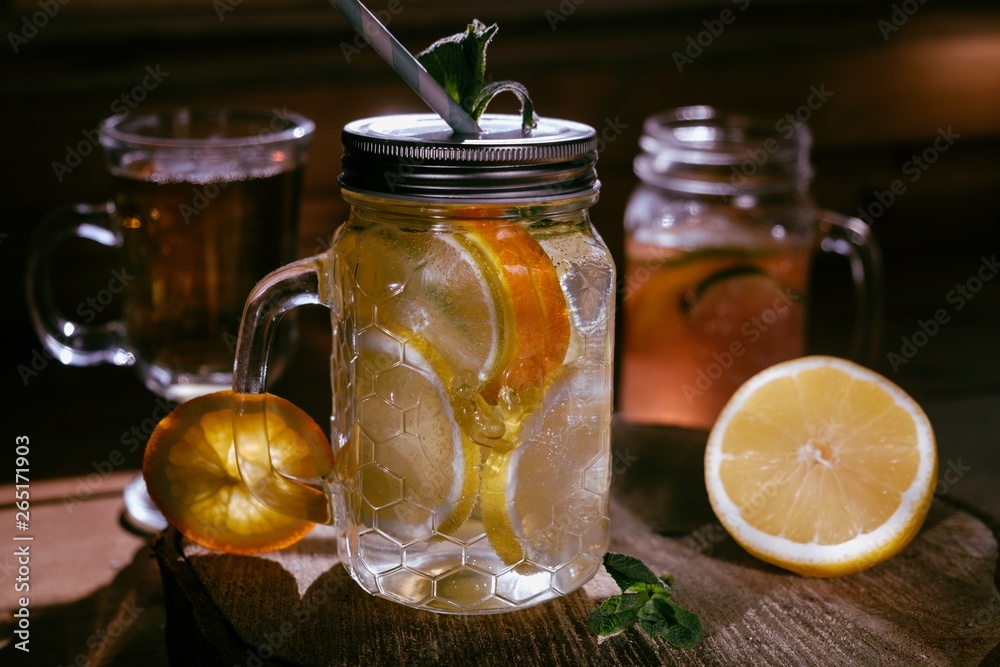 Homemade orange lime lenon lemonade on the dark rustic background Homemade orange lime lenon lemonade on the dark rustic background