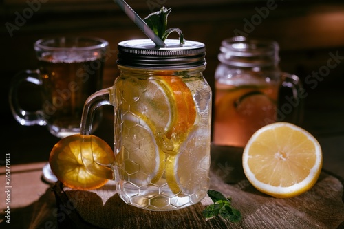 Homemade orange lime lenon lemonade on the dark rustic background photo