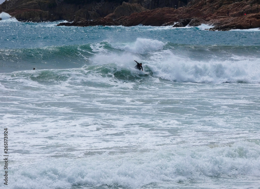 Olas rompiendo en la playa y surfistas esperando la Ola para cabalgarla Olas rompiendo en la playa y surfistas esperando la Ola para cabalgarla