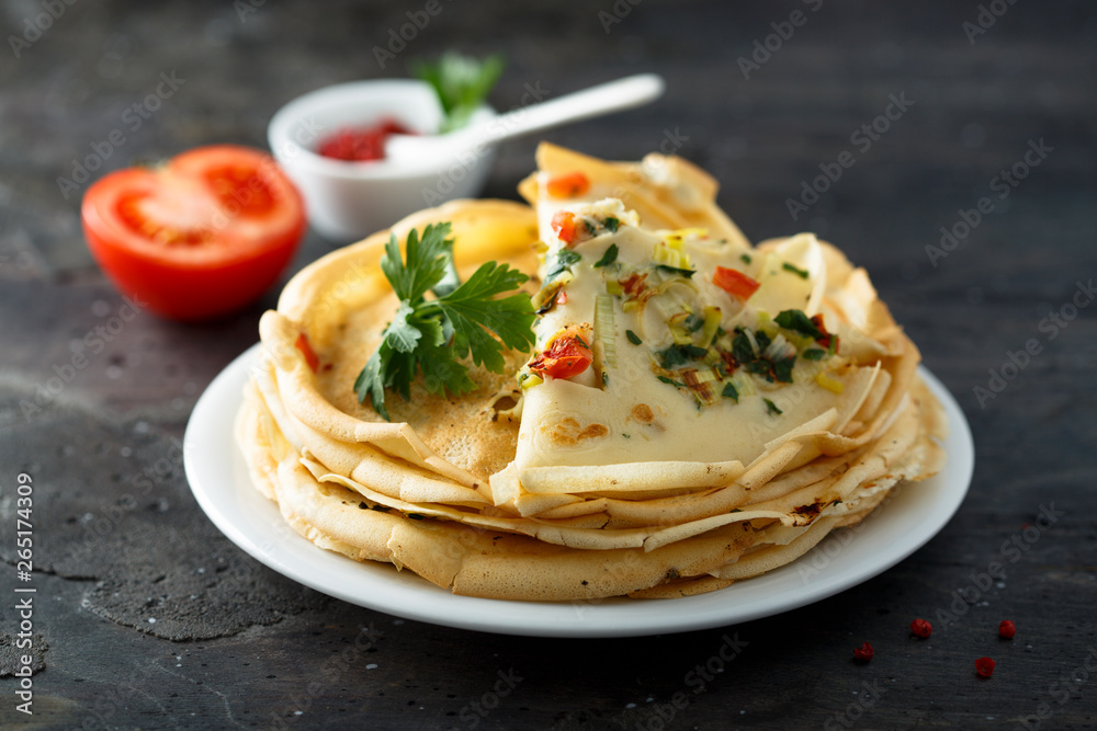 Savory pancakes with tomato, leek and herbs
