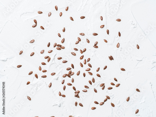 Flax seeds pattern. Brown flax seed on white concrete textured background. Top view or flat lay. Healthy food and diet concept © fascinadora