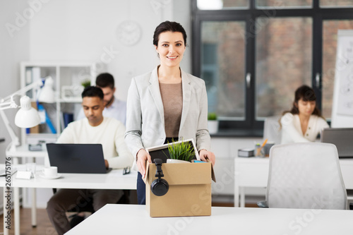 business, new job and corporate concept - happy smiling businesswoman with her personal stuff at office